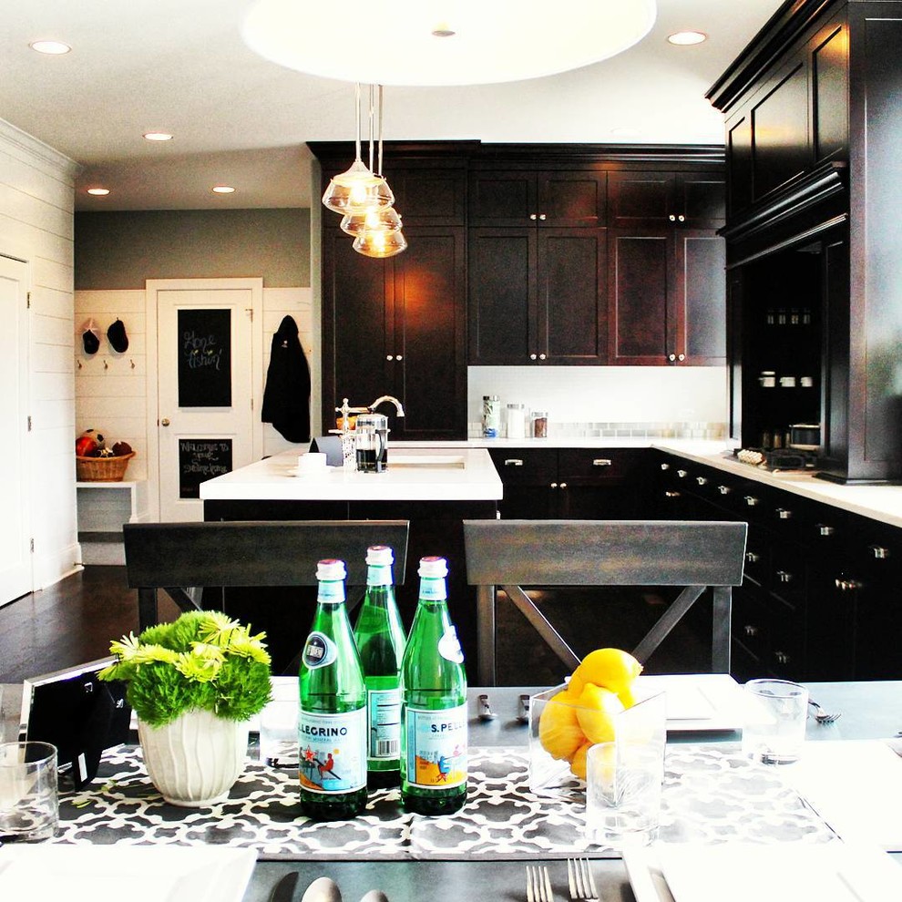 Inspiration for a mid-sized transitional u-shaped dark wood floor eat-in kitchen remodel in Chicago with an undermount sink, recessed-panel cabinets, dark wood cabinets, quartz countertops, metallic backsplash, subway tile backsplash, stainless steel appliances and an island