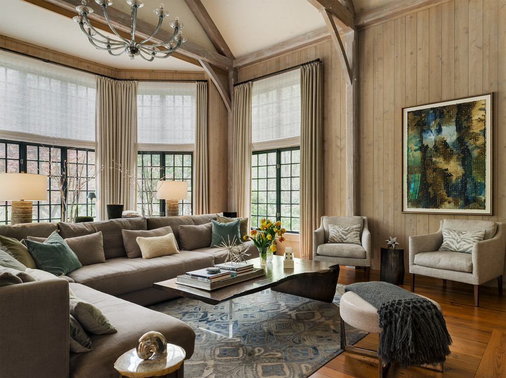 Large transitional family room in New York with medium hardwood floors, brown walls and brown floor.