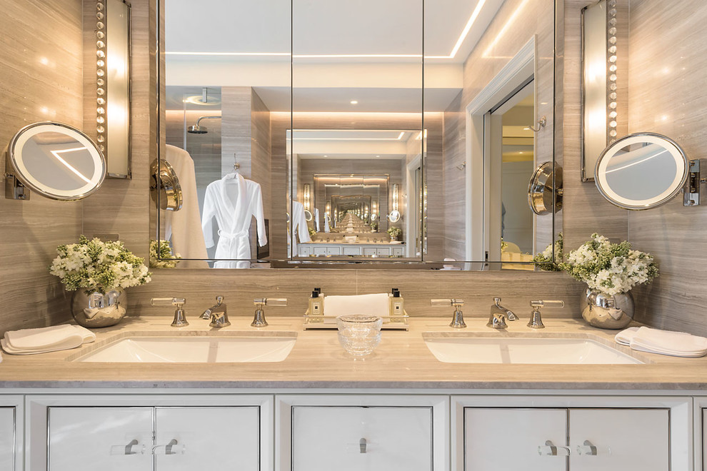 Design ideas for a large contemporary master bathroom in London with flat-panel cabinets, white cabinets, a drop-in tub, an open shower, a wall-mount toilet, marble, mosaic tile floors, a drop-in sink, marble benchtops and a hinged shower door.