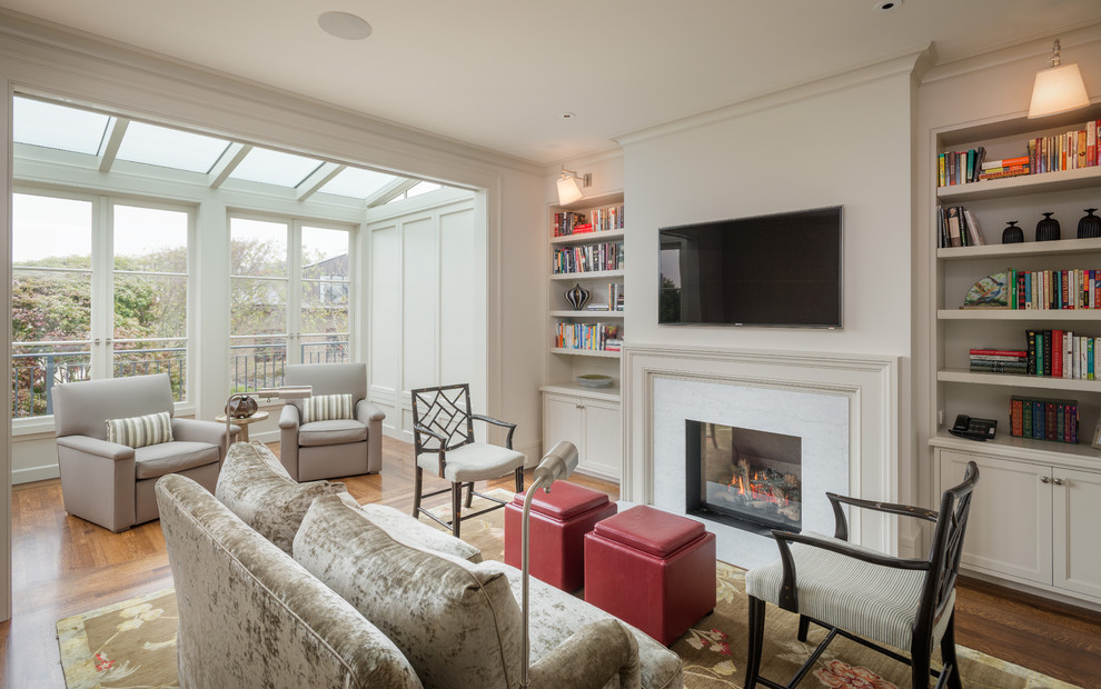 This is an example of a traditional living room in San Francisco with a standard fireplace and a wall-mounted tv.