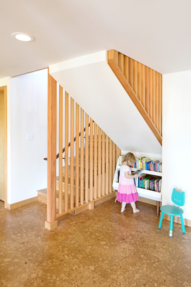 Small midcentury gender-neutral kids' room in Seattle with white walls, cork floors and brown floor.