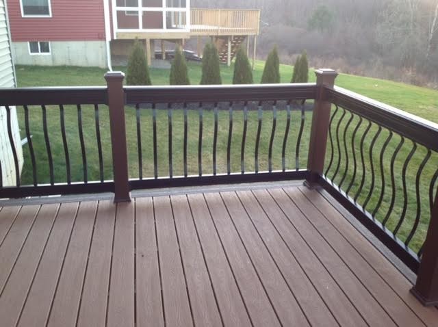 Dark brown Trex deck with contemporary metal railing