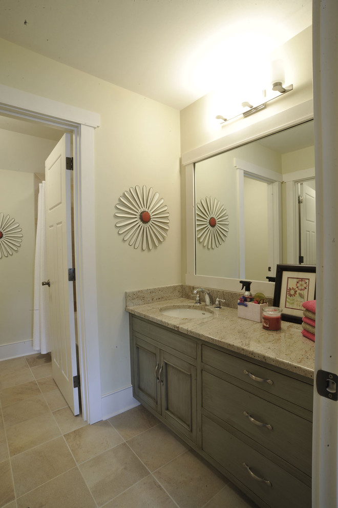 This is an example of a traditional kids bathroom in Columbus with flat-panel cabinets, distressed cabinets, an alcove tub, a shower/bathtub combo, beige walls, an undermount sink, grey floor, a shower curtain, a single vanity and a built-in vanity.