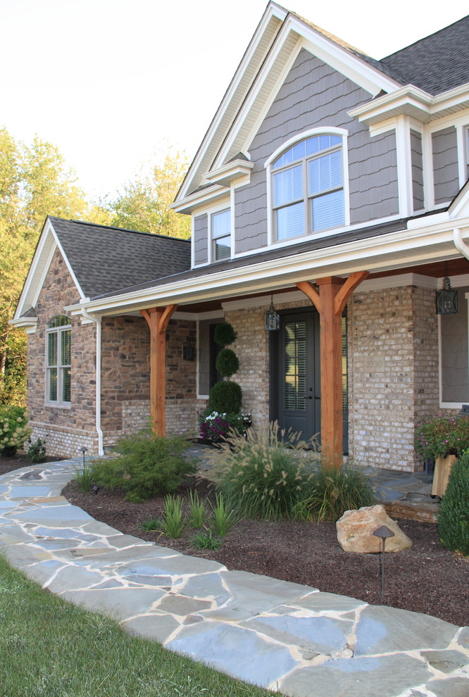 Inspiration for a large rustic gray two-story mixed siding gable roof remodel with a tile roof