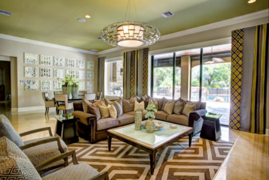 This is an example of a large transitional open concept living room in Orlando with beige walls, marble floors and a built-in media wall.