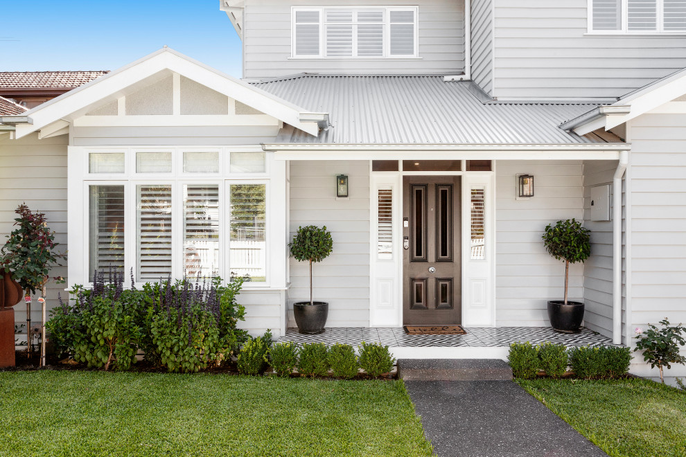 Inspiration for a large two-storey grey house exterior in Melbourne with wood siding, a gable roof, a metal roof and board and batten siding.