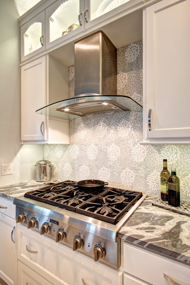 Large transitional u-shaped eat-in kitchen photo in Austin with recessed-panel cabinets, white cabinets, marble countertops, gray backsplash, mosaic tile backsplash, stainless steel appliances and an island