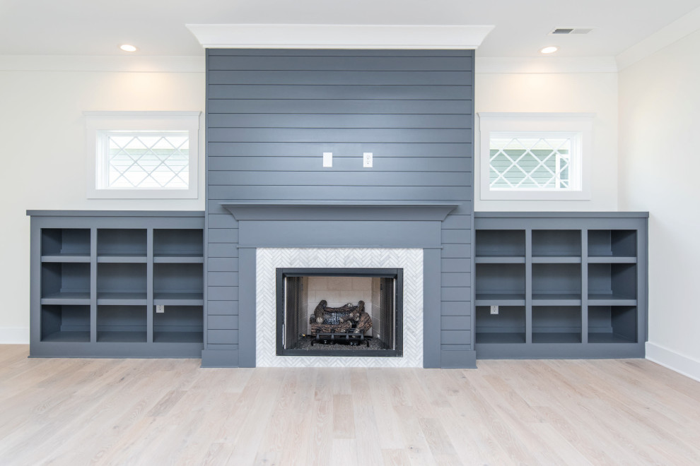 Inspiration for a large coastal open concept light wood floor and shiplap wall living room remodel in Other with a standard fireplace and a tile fireplace
