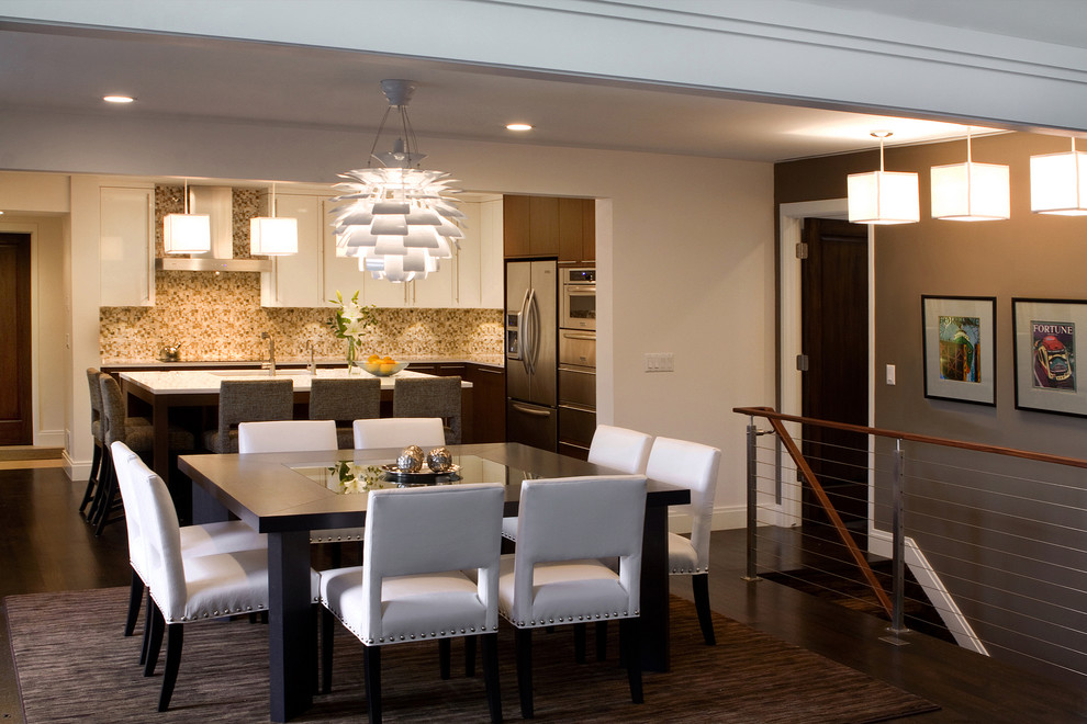 This is an example of a contemporary kitchen/dining combo in Detroit with beige walls and dark hardwood floors.