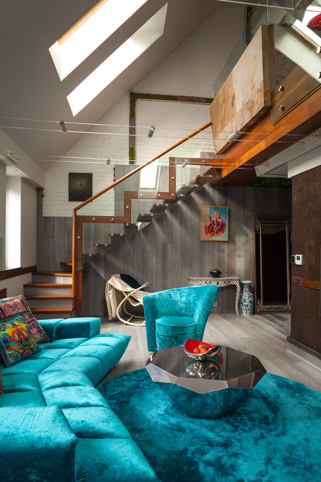 This is an example of a large industrial formal loft-style living room in Moscow with white walls, medium hardwood floors, no fireplace, a wall-mounted tv and grey floor.