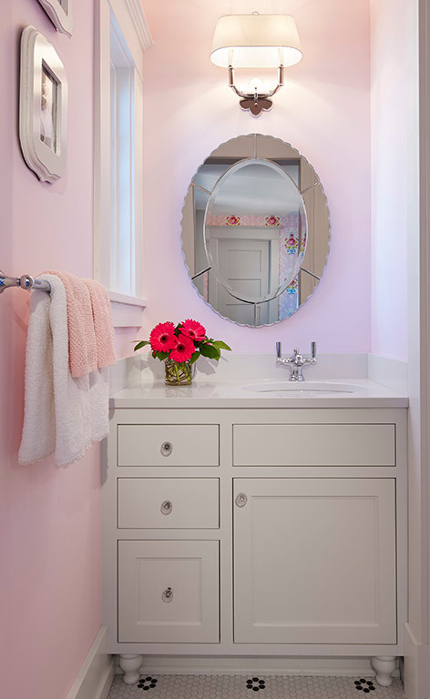 Photo of a transitional bathroom in Minneapolis with furniture-like cabinets, white cabinets, pink walls, ceramic floors, an undermount sink, marble benchtops and white floor.