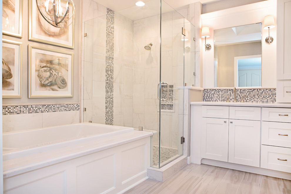 Drop-in bathtub - mid-sized transitional master gray tile and glass tile porcelain tile drop-in bathtub idea in Phoenix with an undermount sink, shaker cabinets, white cabinets, solid surface countertops, a two-piece toilet and gray walls