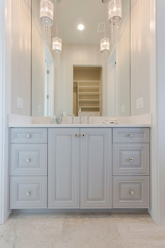 Small beach style powder room in Tampa with raised-panel cabinets, grey cabinets, grey walls, ceramic floors, an undermount sink, marble benchtops, brown floor, white benchtops and a floating vanity.
