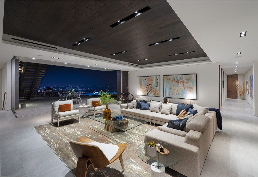 Photo of an expansive modern formal open plan living room in Los Angeles with white walls, porcelain flooring, white floors and a drop ceiling.
