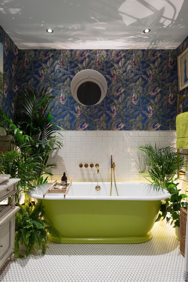 Photo of an eclectic master bathroom in London with a freestanding tub, multi-coloured walls, white tile and subway tile.