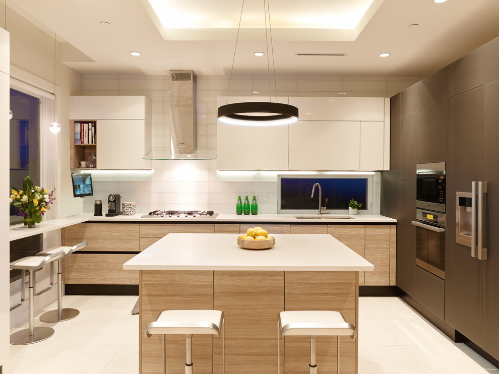 Photo of a small contemporary u-shaped kitchen in Vancouver with a double-bowl sink, flat-panel cabinets, quartz benchtops, white splashback, glass tile splashback, panelled appliances, ceramic floors, with island and white cabinets.