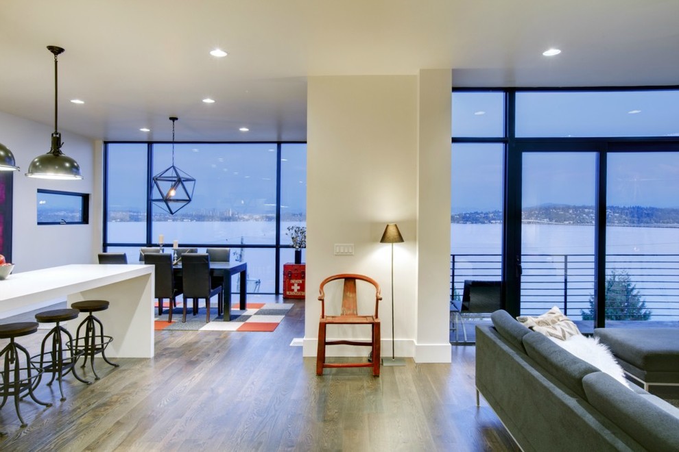 Great room - contemporary dark wood floor great room idea in Seattle with white walls