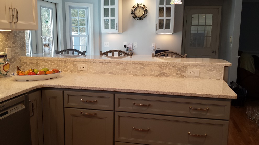 Example of a mid-sized transitional u-shaped kitchen design in Boston with gray cabinets, quartz countertops, gray backsplash, mosaic tile backsplash, stainless steel appliances and a peninsula