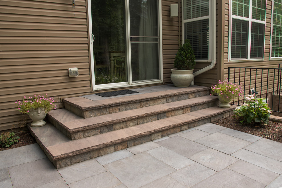 Inspiration for a mid-sized backyard patio in DC Metro with concrete pavers.