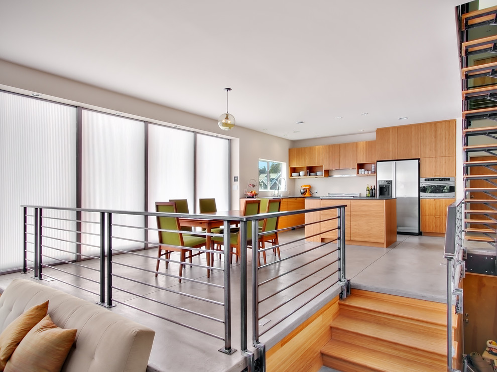 Modern kitchen/dining combo in Seattle with white walls.