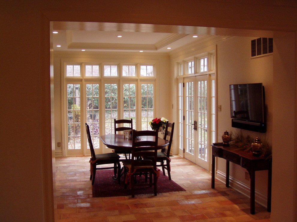 Photo of a traditional kitchen/dining combo in St Louis with terra-cotta floors.