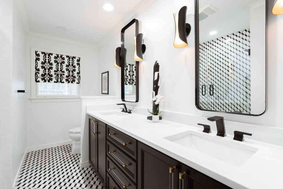 This is an example of a mid-sized transitional bathroom in Oklahoma City with shaker cabinets, black cabinets, black and white tile, white walls, engineered quartz benchtops, black floor, a hinged shower door, white benchtops, a double vanity and a built-in vanity.