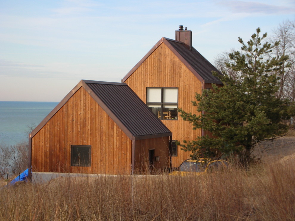 Inspiration for a traditional two-storey brown exterior in Chicago with wood siding and a gable roof.