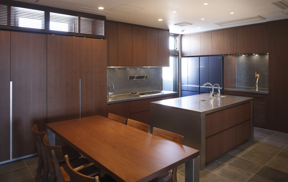 Eat-in kitchen in Other with dark wood cabinets, stainless steel benchtops, ceramic floors, with island and grey floor.