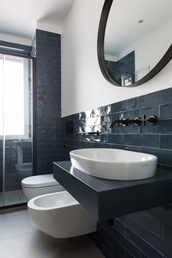 Design ideas for a small contemporary 3/4 bathroom in Rome with blue cabinets, an alcove shower, a wall-mount toilet, blue tile, porcelain tile, white walls, porcelain floors, a vessel sink, wood benchtops, beige floor, a hinged shower door, blue benchtops, a single vanity, a floating vanity and brick walls.