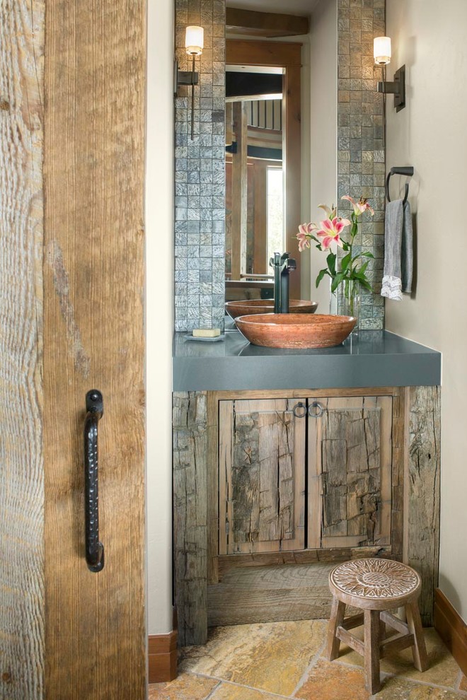 This is an example of a small country powder room in Denver with raised-panel cabinets, medium wood cabinets, slate, beige walls, slate floors, a vessel sink, engineered quartz benchtops, multi-coloured floor, grey benchtops, gray tile and a built-in vanity.