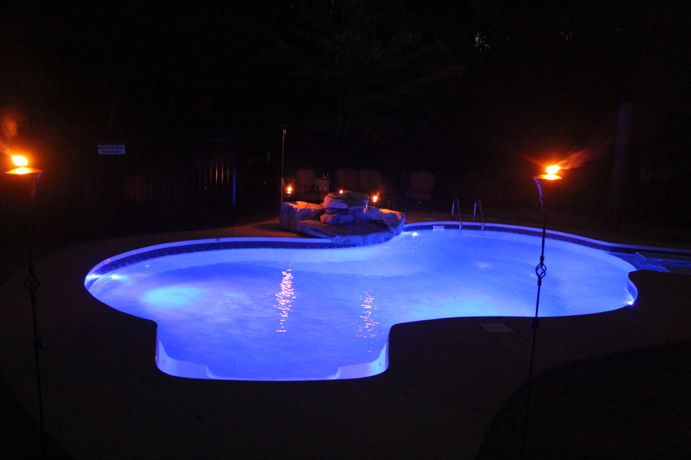 Pool - large backyard custom-shaped pool idea