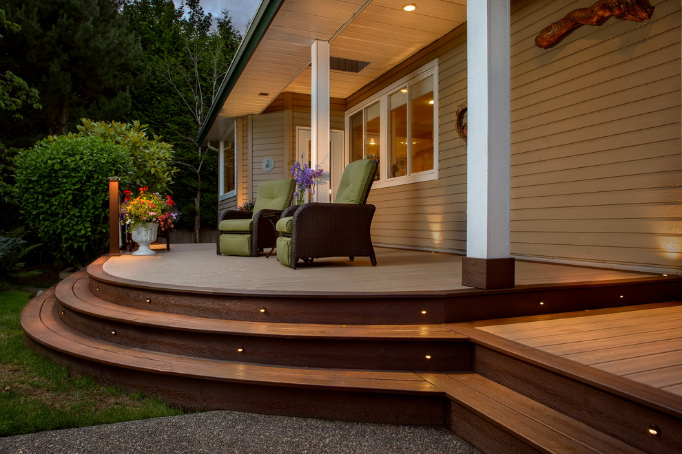 Example of a mid-sized transitional backyard deck design in Vancouver with a roof extension