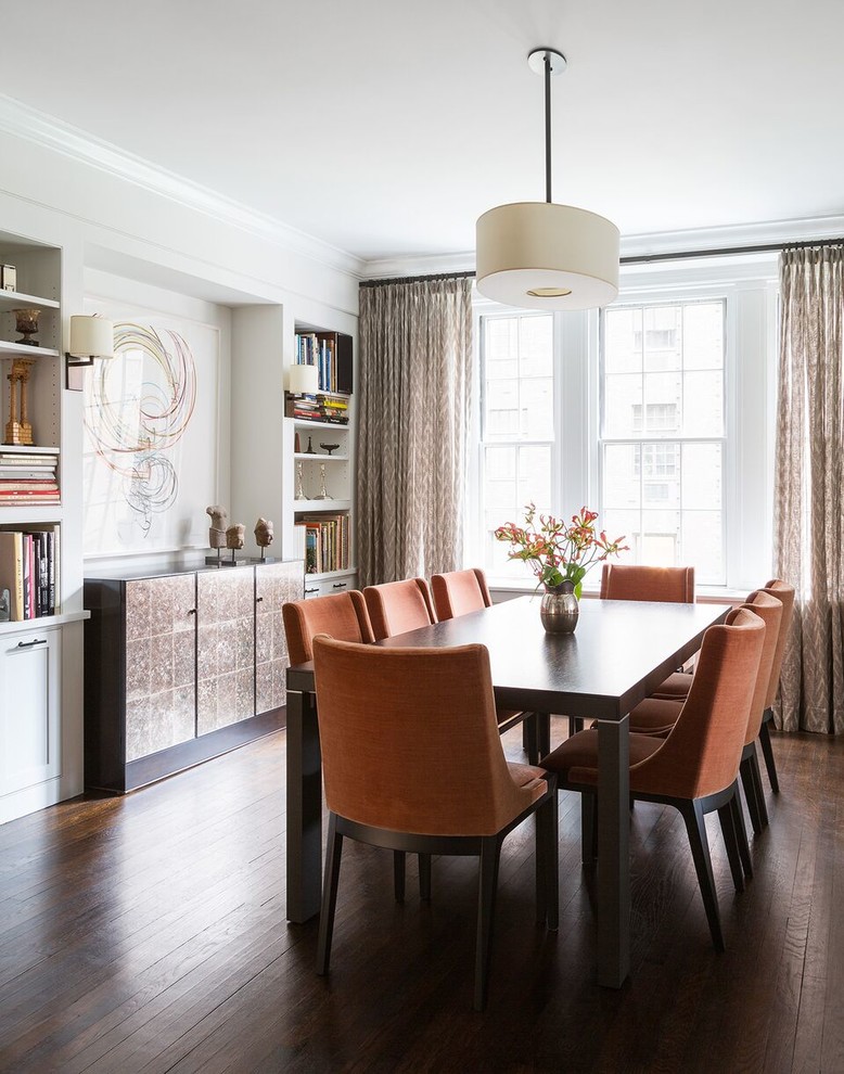 This is an example of a transitional dining room in New York with white walls and dark hardwood floors.