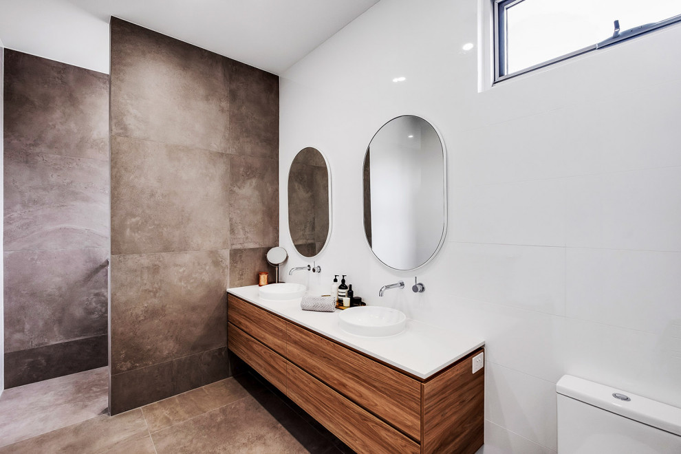 Inspiration for a medium sized modern ensuite bathroom in Adelaide with freestanding cabinets, white cabinets, a walk-in shower, grey tiles, porcelain flooring, grey floors, an open shower, white worktops, double sinks and a floating vanity unit.