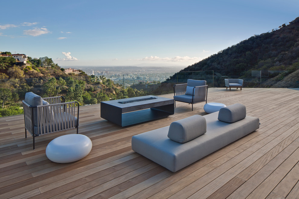 This is an example of an expansive contemporary backyard deck in Los Angeles with no cover.