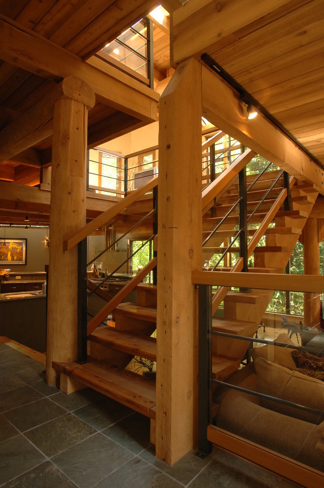 This is an example of a mid-sized contemporary wood straight staircase in Vancouver with open risers and mixed railing.