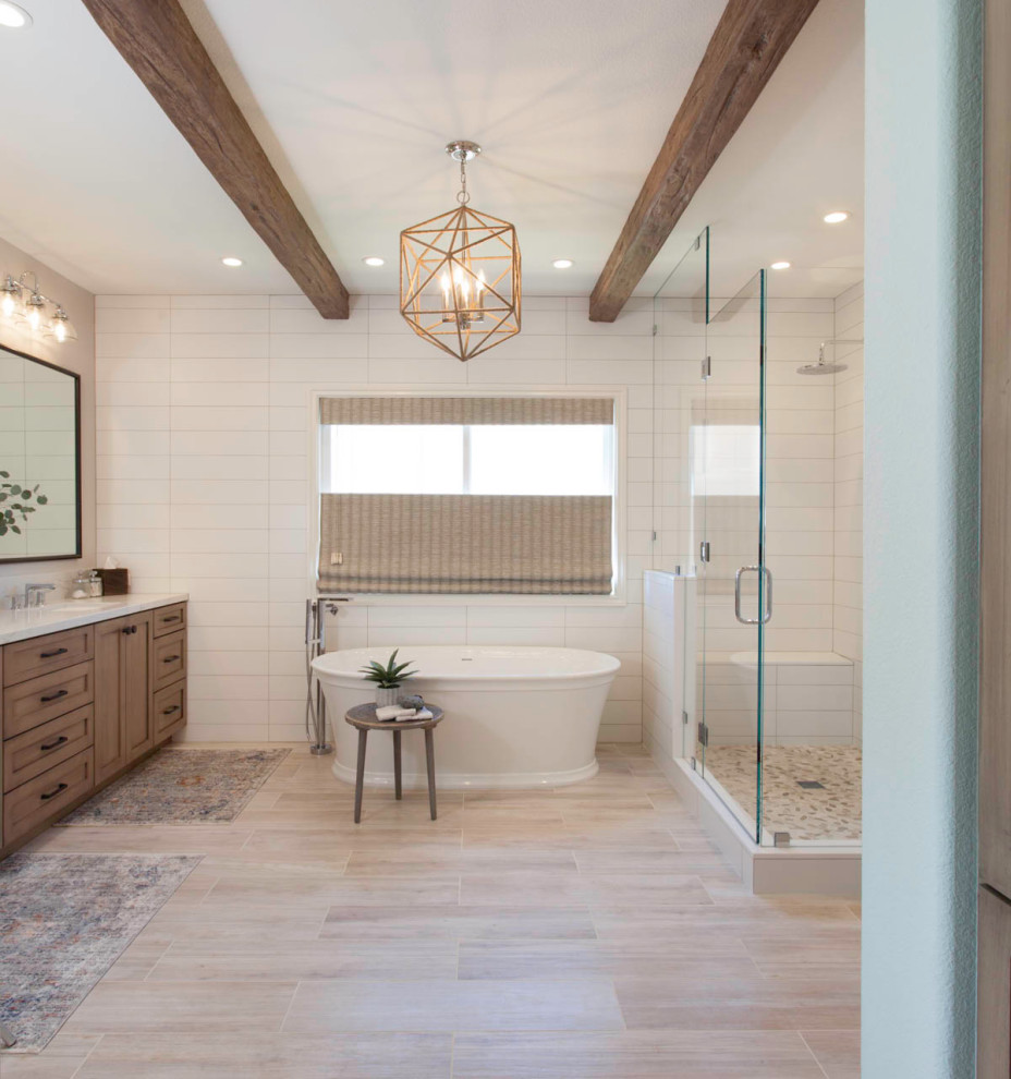 Photo of a large rural ensuite bathroom in San Diego with recessed-panel cabinets, brown cabinets, a freestanding bath, an alcove shower, a two-piece toilet, white tiles, cement tiles, white walls, porcelain flooring, a submerged sink, engineered stone worktops, brown floors, a hinged door, white worktops, a shower bench, double sinks, a built in vanity unit, exposed beams and tongue and groove walls.
