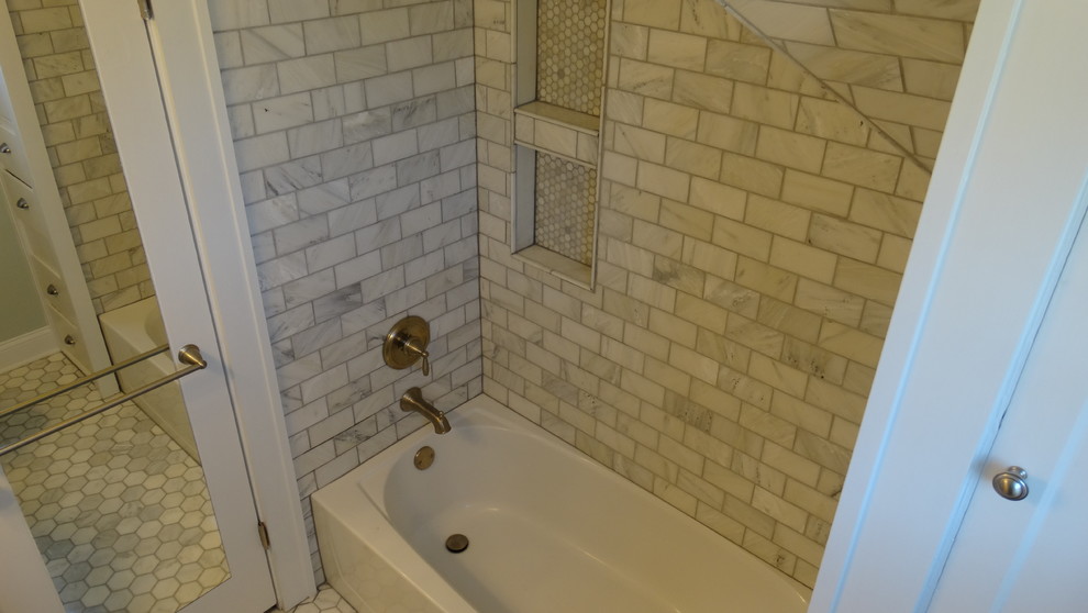 Photo of a small modern 3/4 bathroom in Cleveland with a pedestal sink, an alcove tub, a shower/bathtub combo, gray tile, subway tile and marble floors.