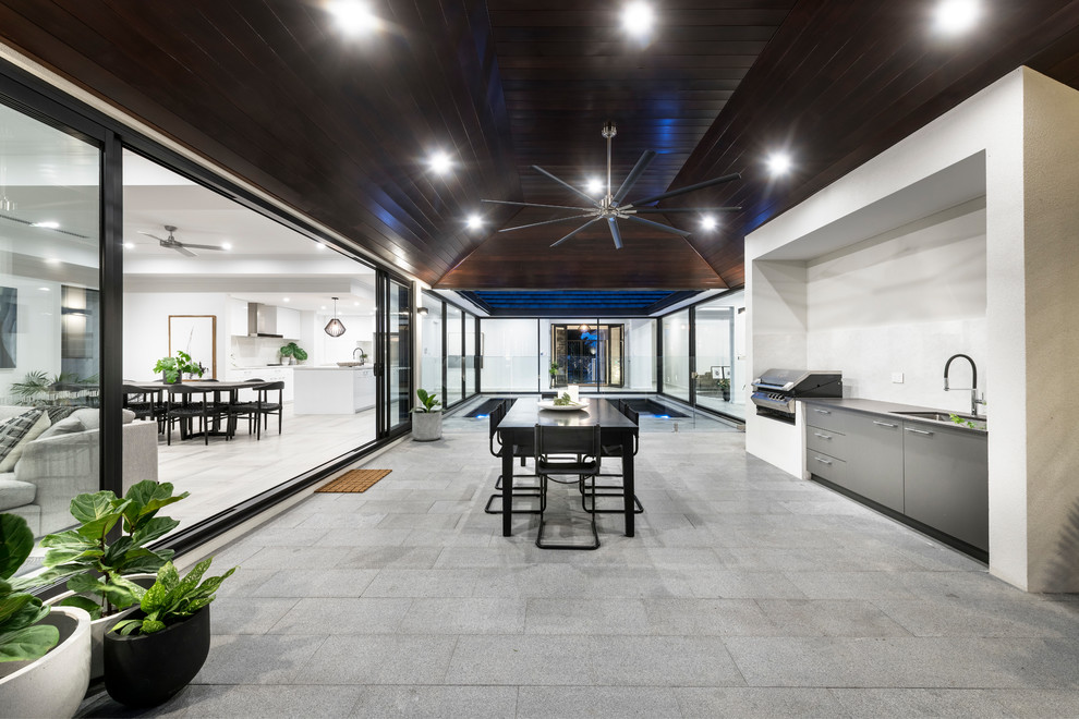Design ideas for a large contemporary backyard patio in Perth with an outdoor kitchen.