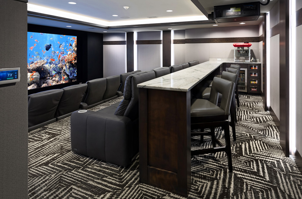 This is an example of an expansive transitional enclosed home theatre in Omaha with white walls, carpet, a projector screen and grey floor.