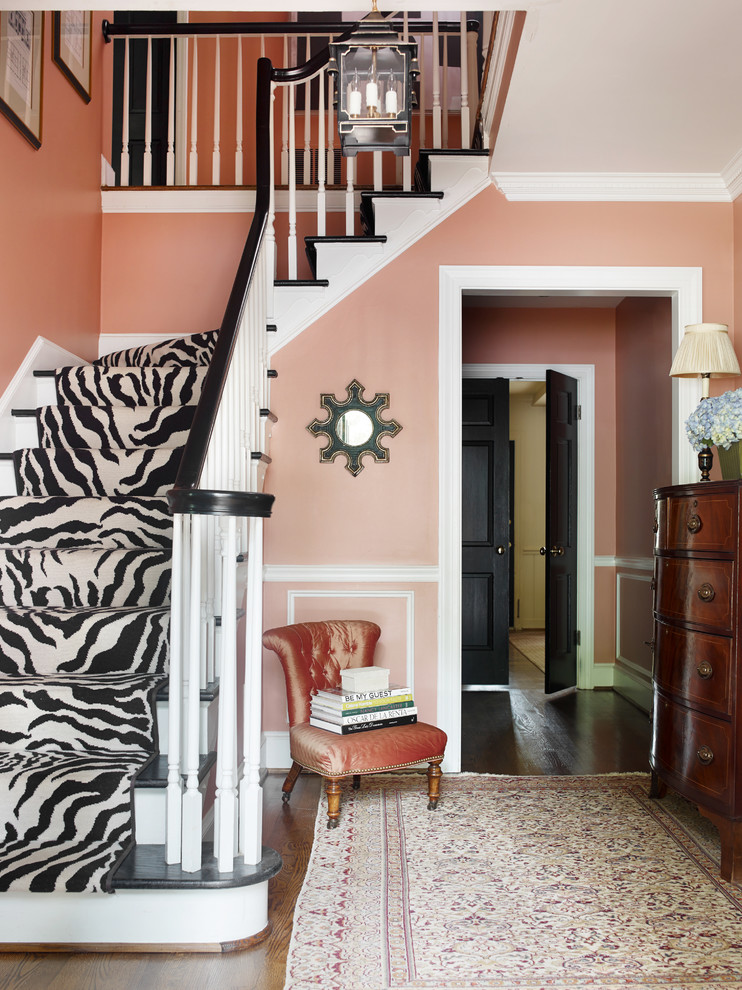 Inspiration for a traditional foyer in Charlotte with pink walls, dark hardwood floors and a single front door.