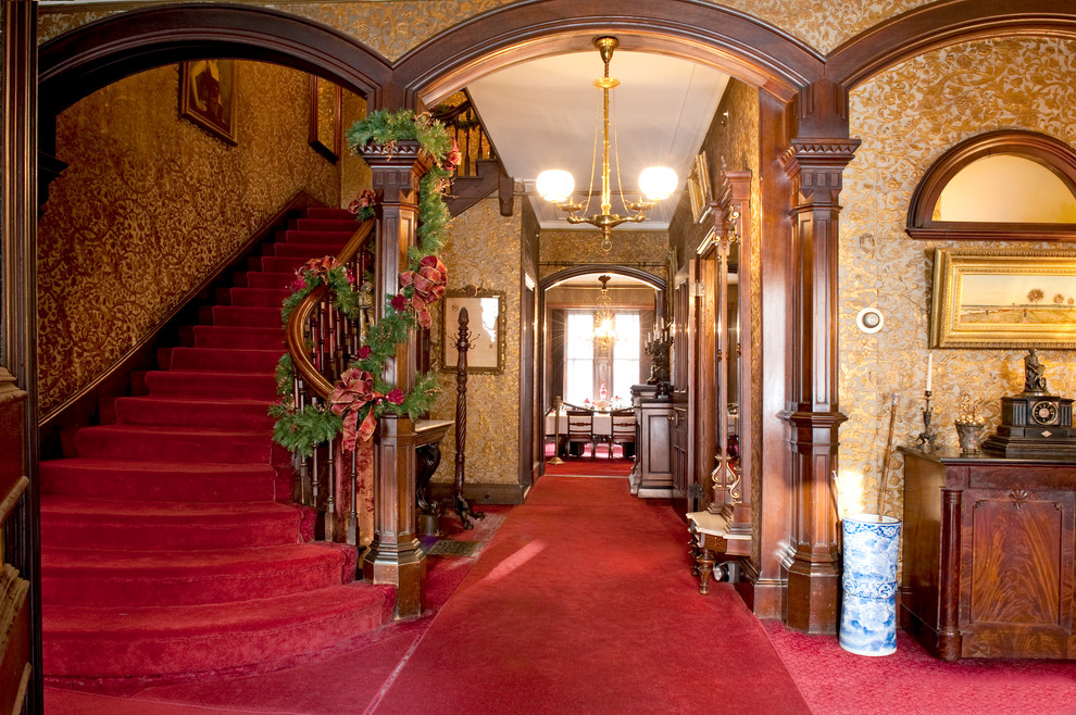 This is an example of a traditional foyer in Boston with carpet.