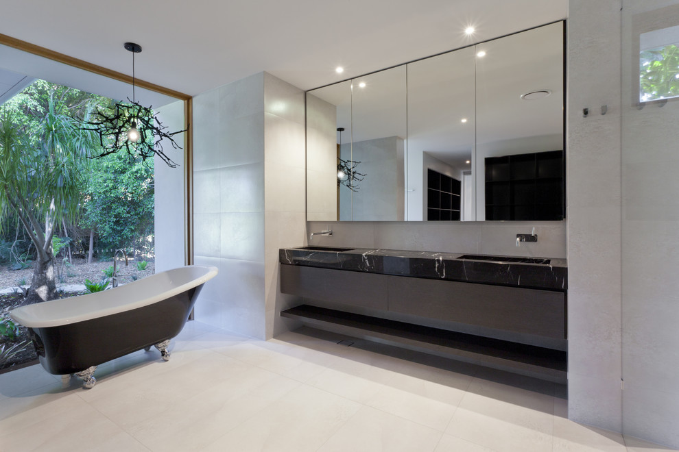 Photo of a mid-sized modern master bathroom in DC Metro with flat-panel cabinets, black cabinets, a freestanding tub, an open shower, a two-piece toilet, black and white tile, ceramic tile, grey walls, concrete floors, an undermount sink and marble benchtops.