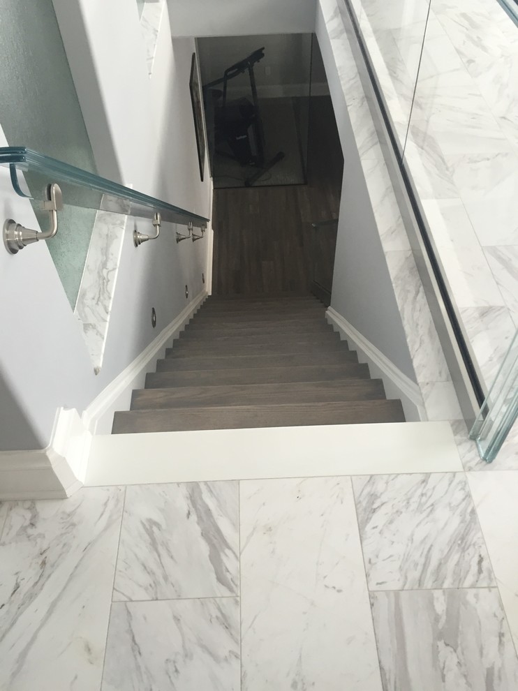 Photo of a mid-sized modern wood straight staircase in New York with painted wood risers.
