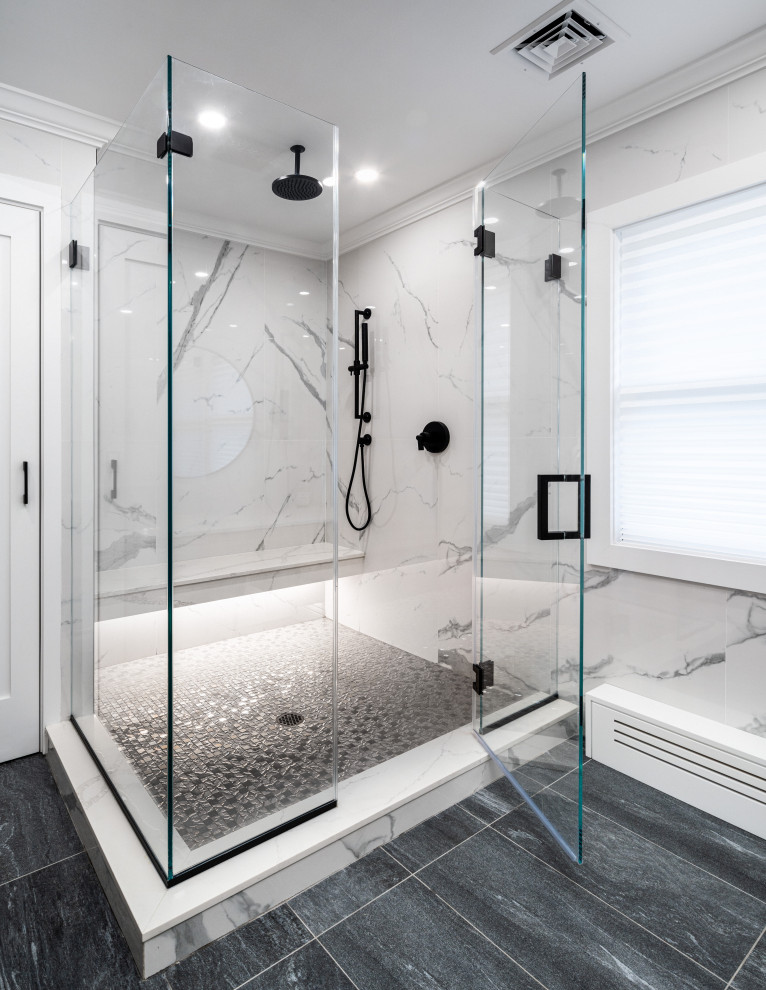 Mid-sized modern bathroom in New York with flat-panel cabinets, light wood cabinets, a wall-mount toilet, white tile, marble, white walls, porcelain floors, an undermount sink, engineered quartz benchtops, grey floor, a hinged shower door, white benchtops and a double vanity.