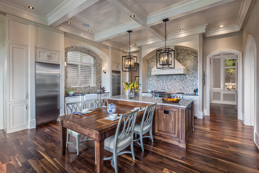 Example of a classic dark wood floor eat-in kitchen design with white cabinets, granite countertops, multicolored backsplash, mosaic tile backsplash, stainless steel appliances, an island and beaded inset cabinets
