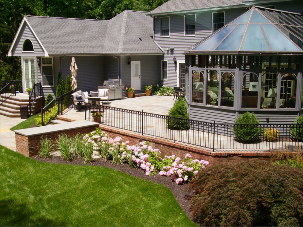 Inspiration for a traditional backyard patio in Other with concrete pavers.