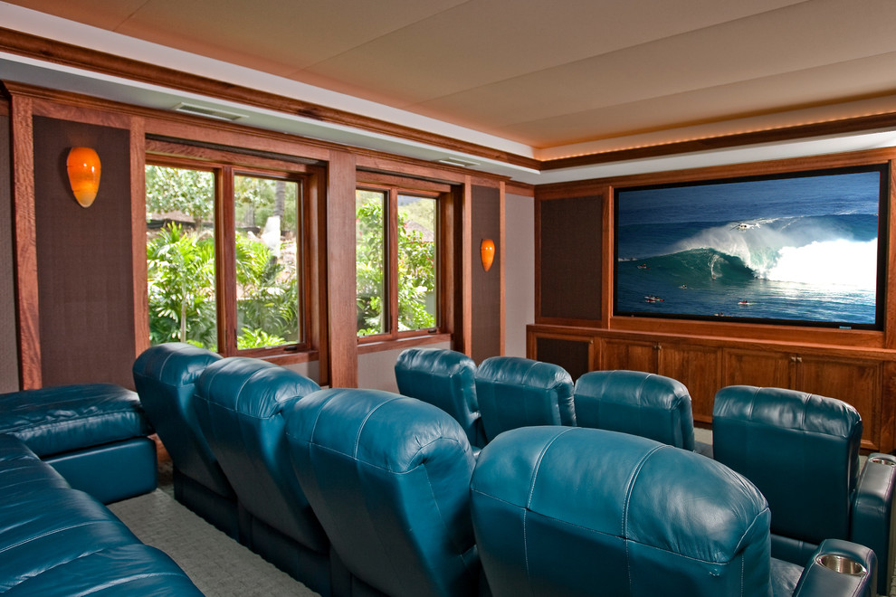 Design ideas for a large tropical enclosed home theatre in Los Angeles with brown walls, carpet and a projector screen.