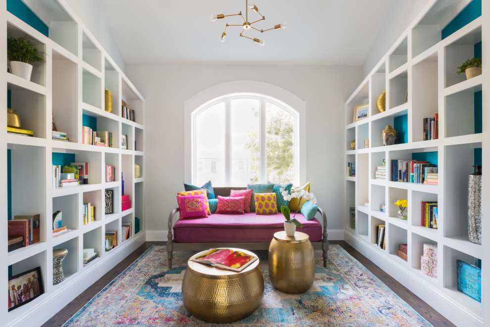 Inspiration for a transitional enclosed family room in Boston with a library, white walls, medium hardwood floors, no tv, brown floor and vaulted.