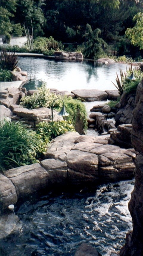 This is an example of a traditional backyard garden in San Diego with with pond.